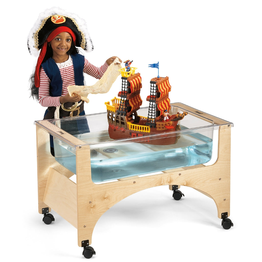 Child playing with a pirate-themed toy set on a sensory table