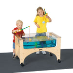 Two children playing a fishing game at a sensory table on a white background