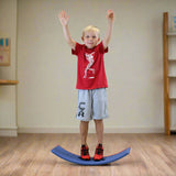 Boy standing on seesaw balance board