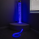 Bubble tube glowing blue with fibre optic strands and corner seating