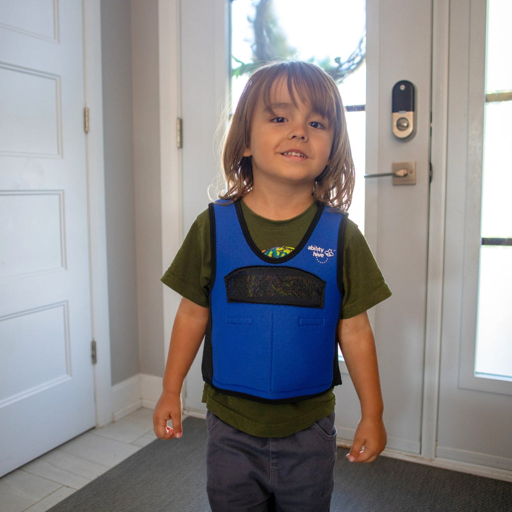 Child wearing blue and black weighted vest